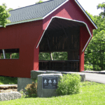 romantic destinations in Indiana. Photo shows a red covered bridge